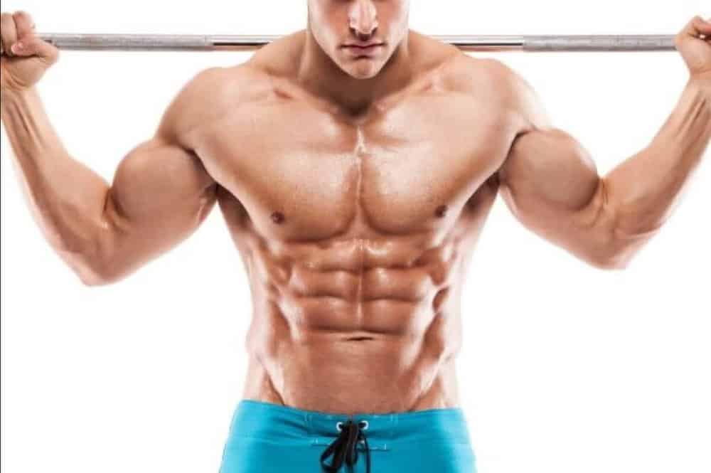 Shirtless muscular man holding barbell